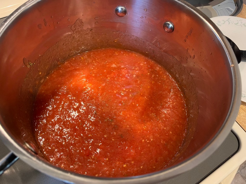 the inside of a giant pot full of pizza sauce. It looks delicious and bubbly
