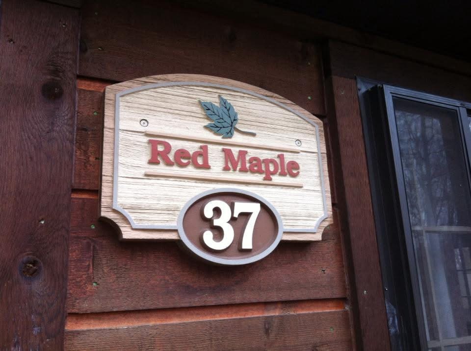 A sign above a number denoting this cabin as Red Maple 37