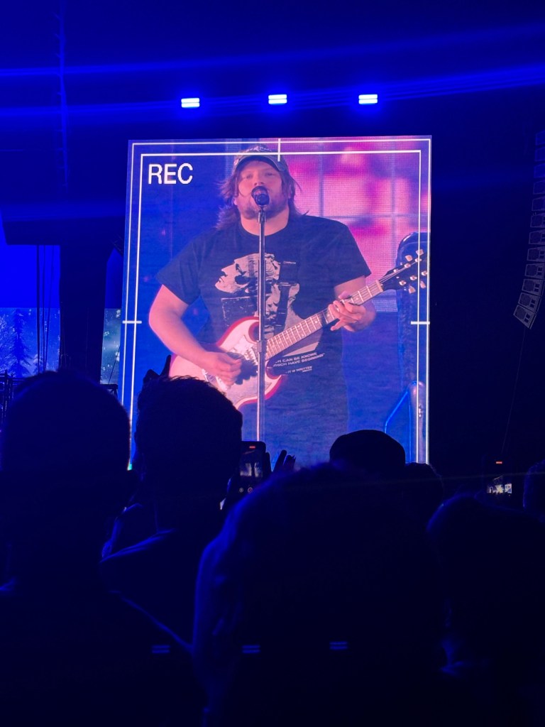 Patrick Stump of Fall Out Boy on the big screen at the concert